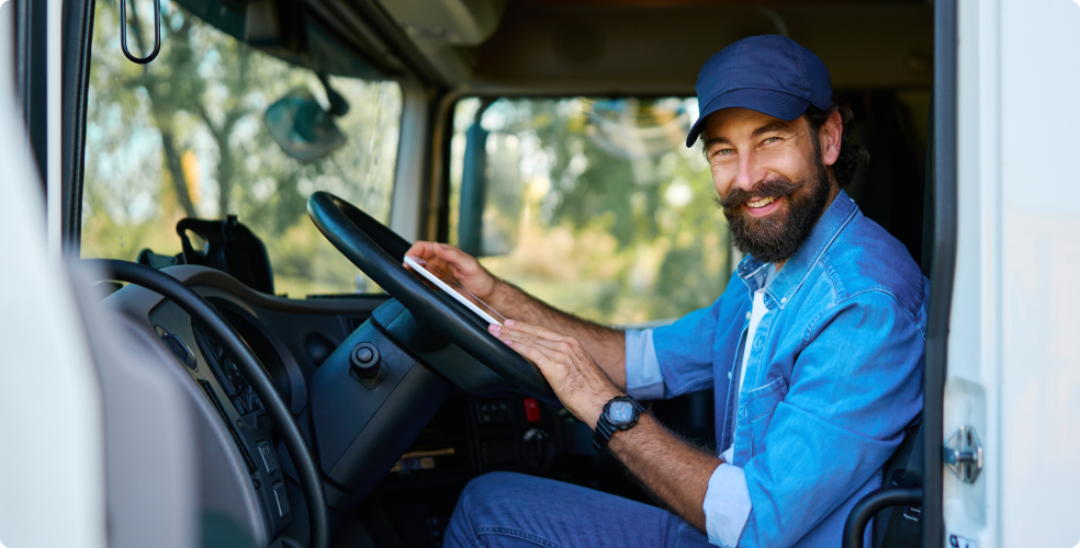 Bearded man driving a truck