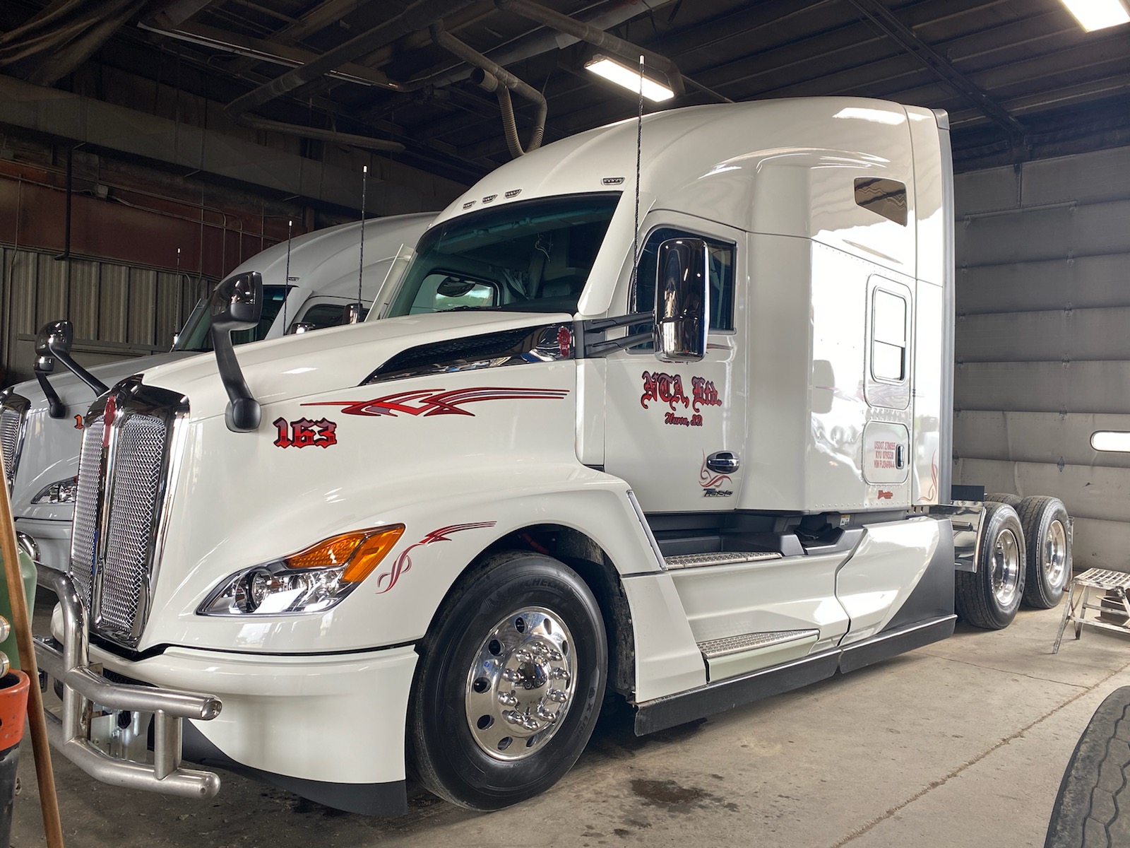 White semi truck parked inside warehouse